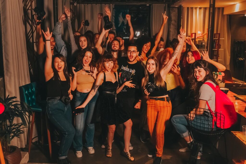 group of young multiethnic cheerful colleagues having party after workday