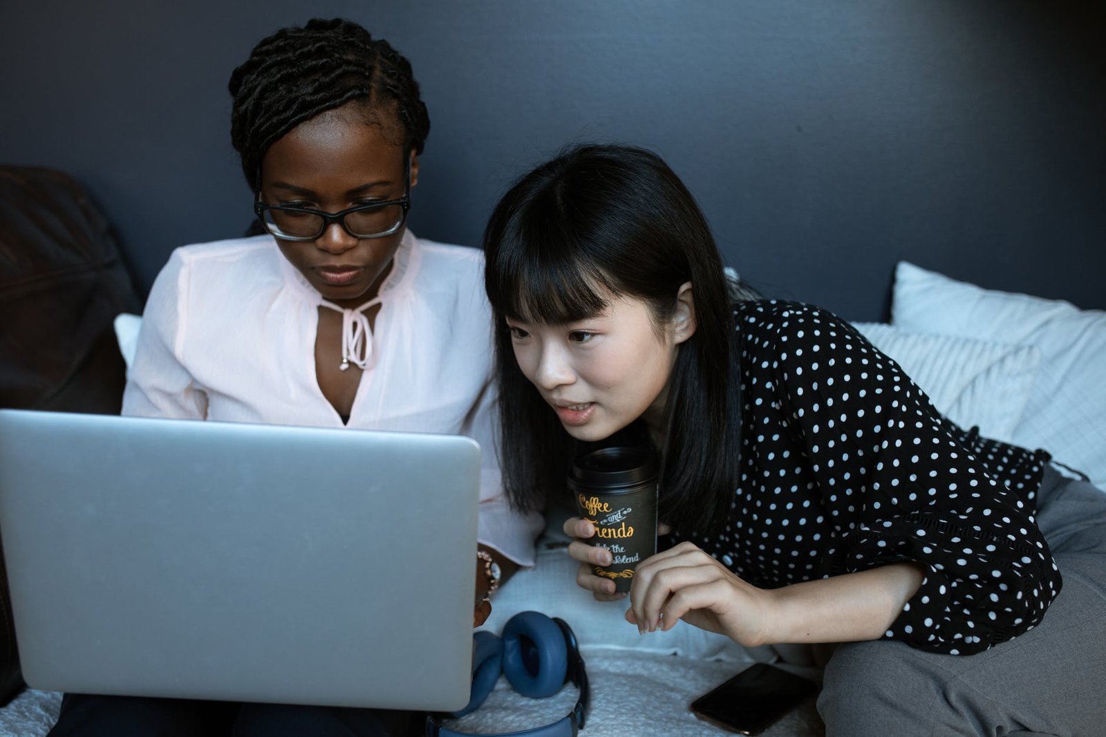 photo of women helping each other at work